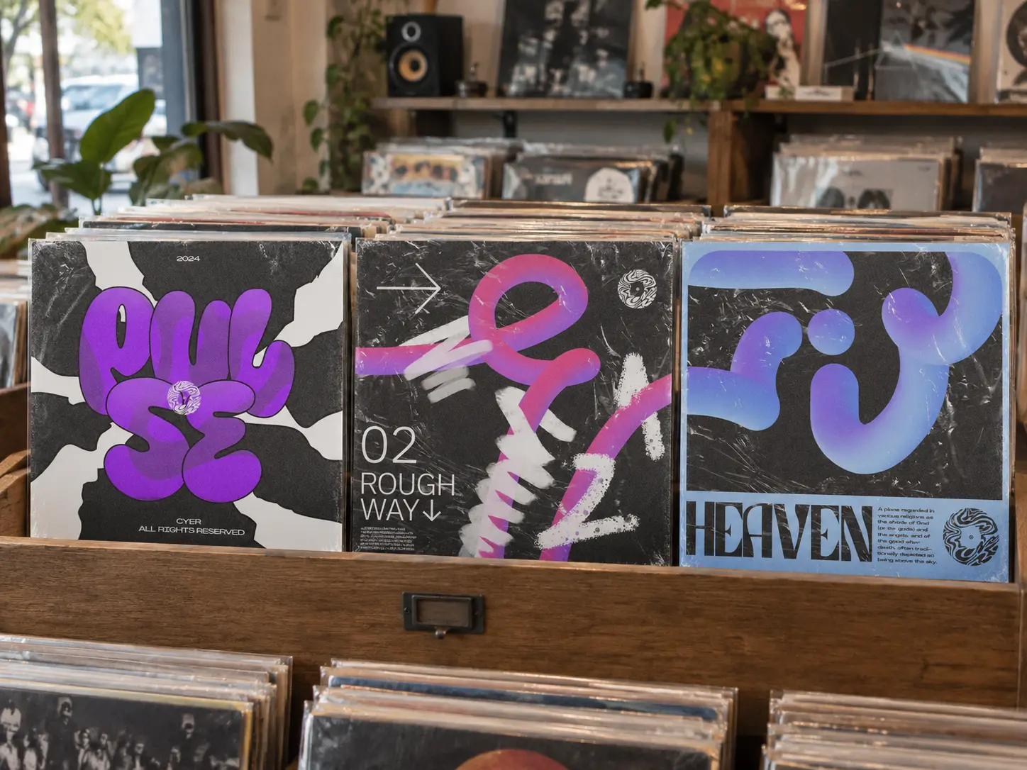The Pulse, Rough Way and Heaven sleeves standing side by side in a wooden record crate in a small record shop.