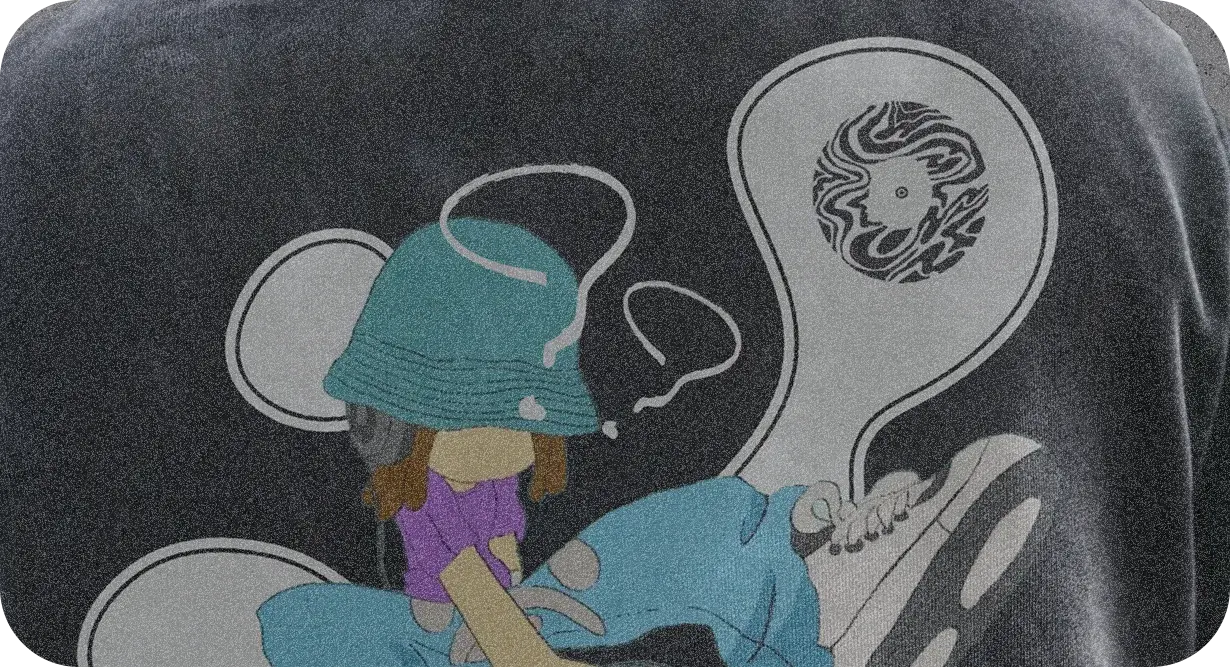 Close-up of the hoodie print: the character in a bucket hat, and the mark inside a bubble.