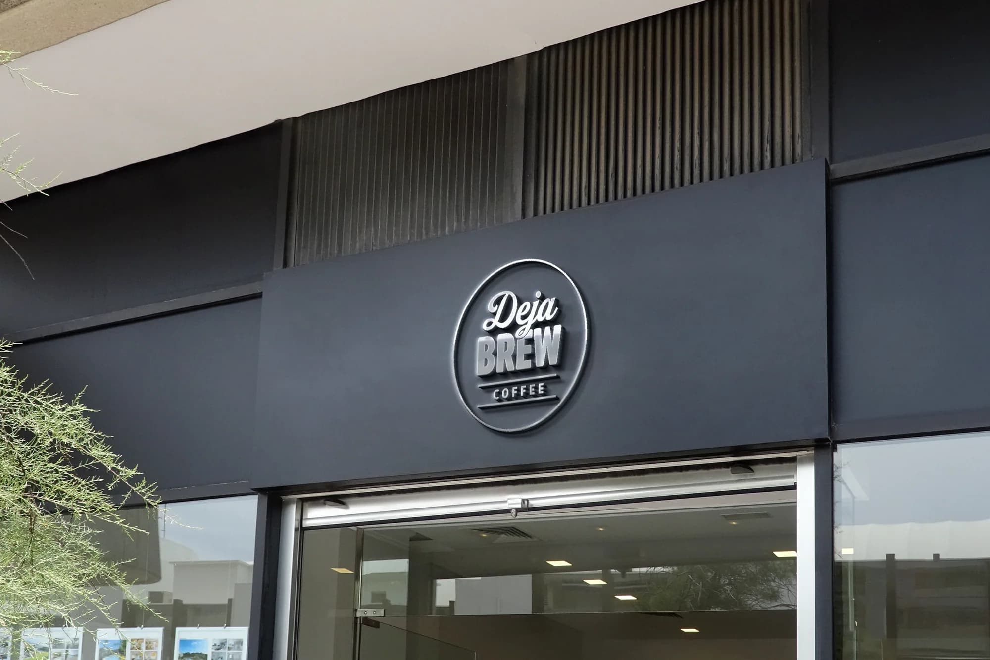 Mock-up: the badge as a raised sign on a dark grey shopfront.