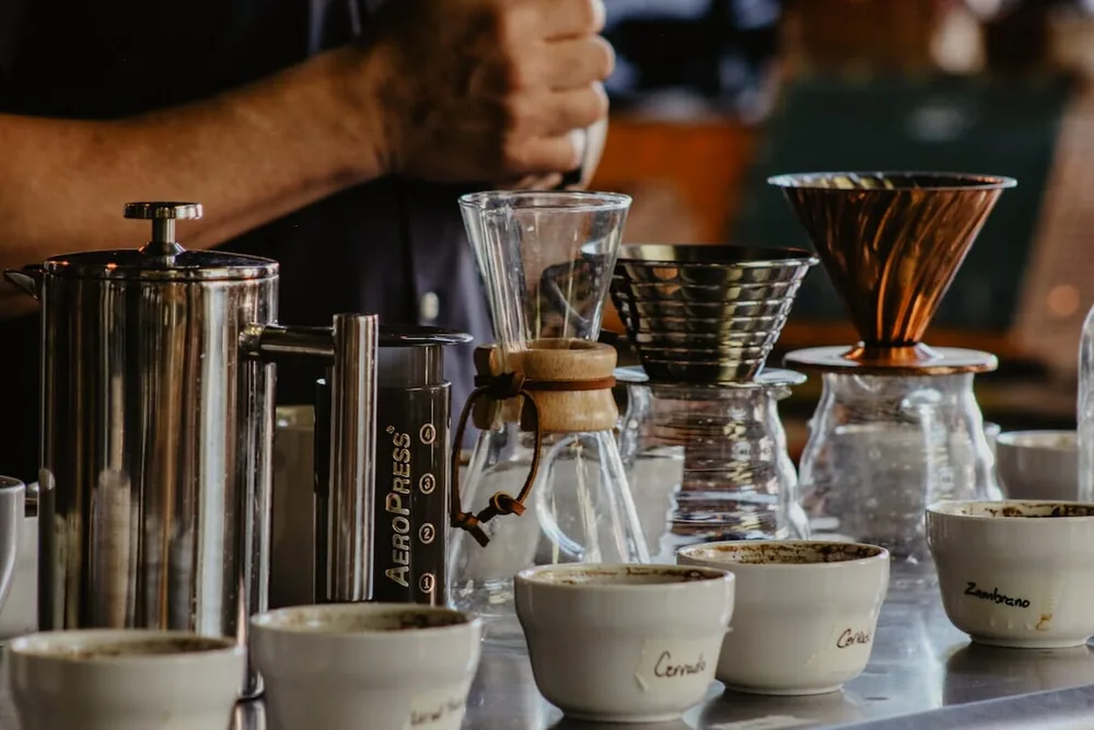 Pour-over brewers and a French press on a café counter.