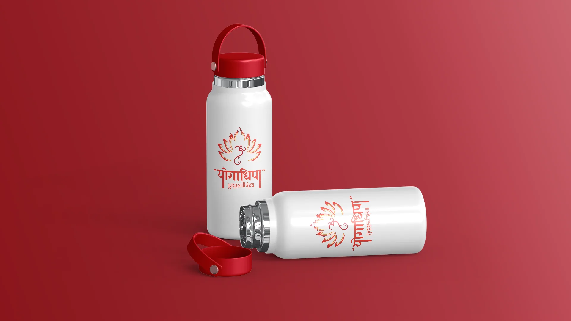 Two white insulated bottles with red caps, printed with the full Yogadhipa logo, one standing and one lying down.